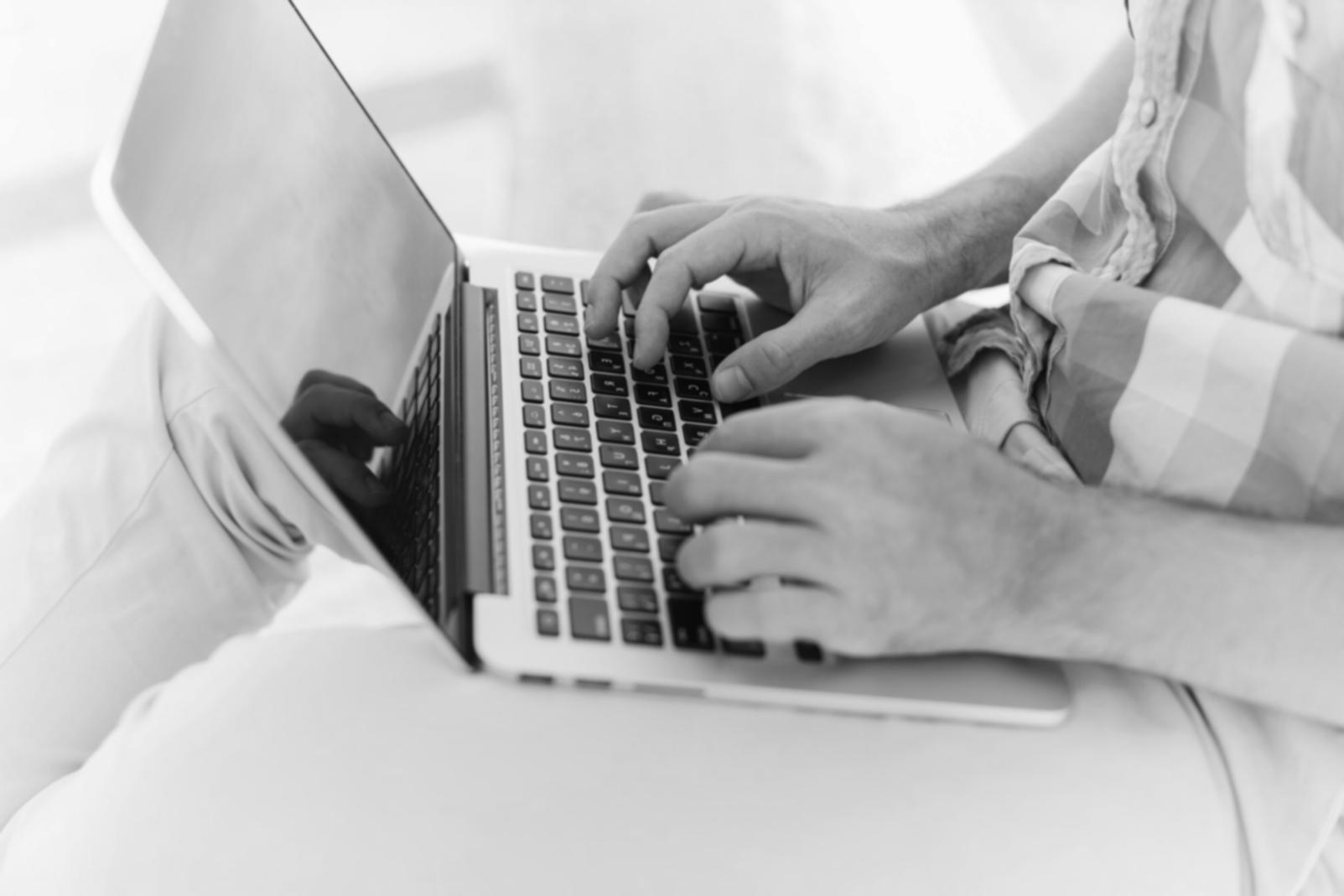 Professional analyzing consolidated budget reports on computer screen